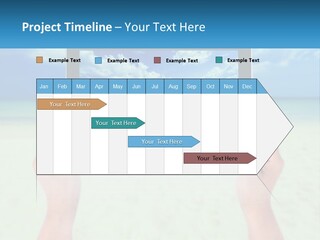 A Person Holding A Tablet With A Beach In The Background PowerPoint Template