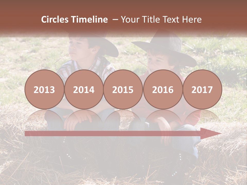 Two Children In Cowboy Hats Sitting On A Pile Of Hay PowerPoint Template