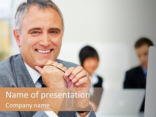 A Man In A Business Suit Sitting In Front Of A Laptop PowerPoint Template