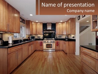 A Kitchen With Wooden Cabinets And Black Counter Tops PowerPoint Template