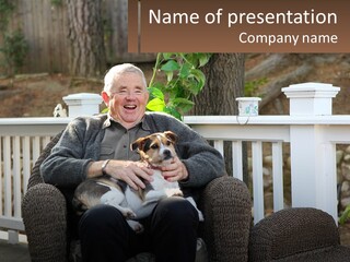 A Man Sitting On A Chair Holding A Dog PowerPoint Template