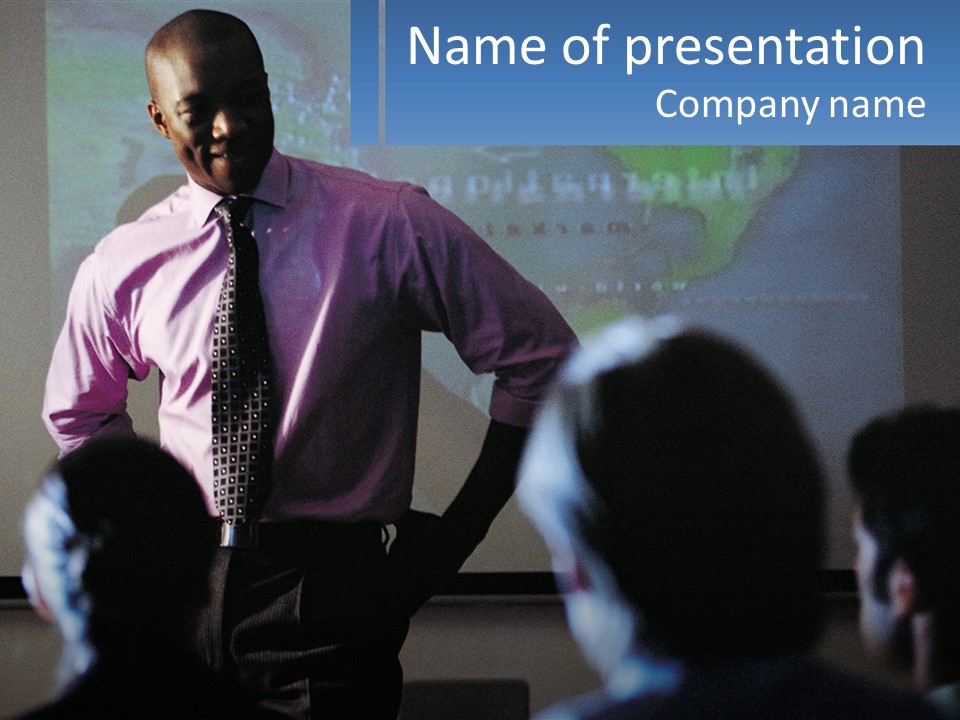 A Man In A Pink Shirt And Tie Standing In Front Of A Projector Screen PowerPoint Template