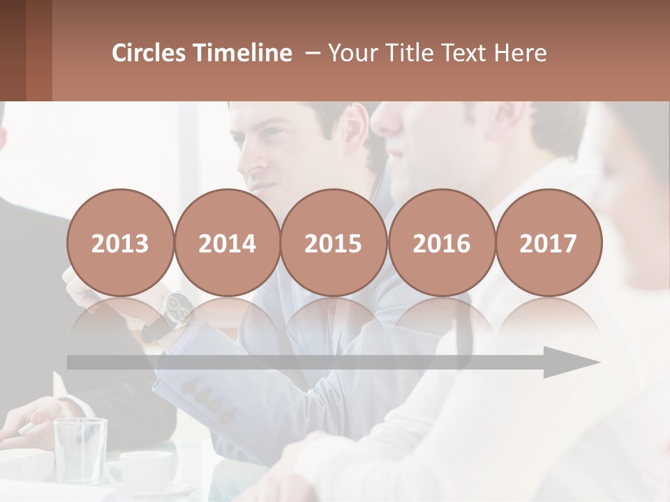 A Group Of People Sitting At A Table In A Meeting PowerPoint Template