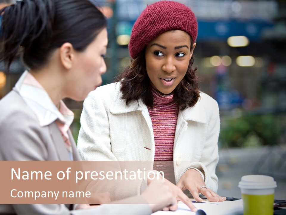 Two Women Sitting At A Table Talking To Each Other PowerPoint Template