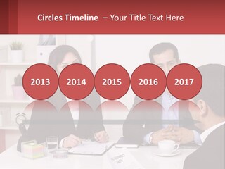A Group Of People Sitting Around A Table Talking PowerPoint Template
