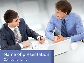 Two Men Sitting At A Table In Front Of A Laptop PowerPoint Template