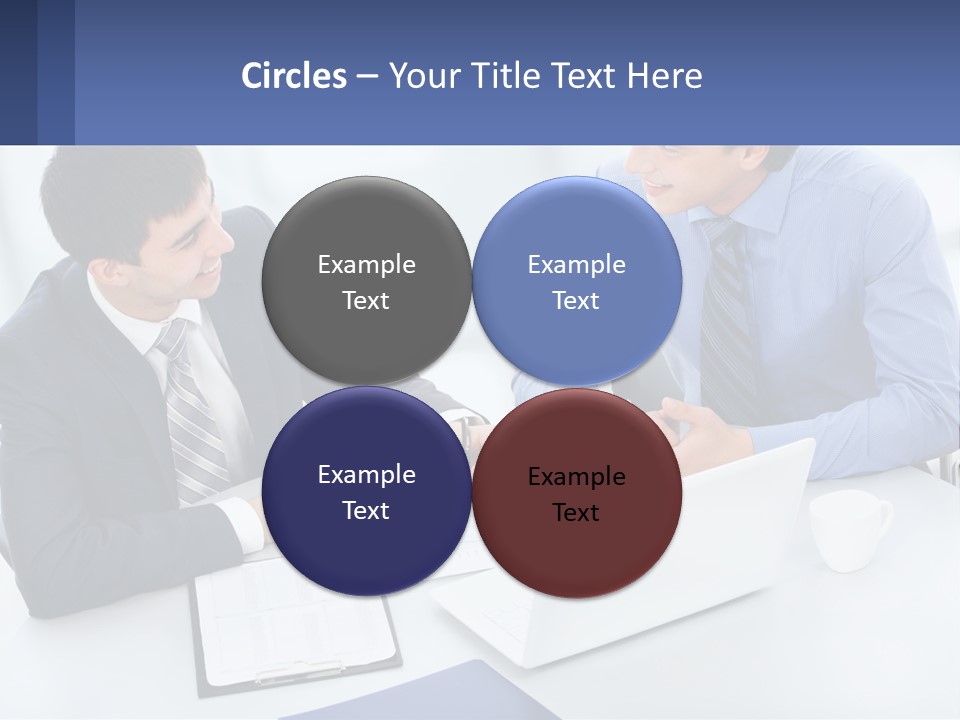 Two Men Sitting At A Table In Front Of A Laptop PowerPoint Template