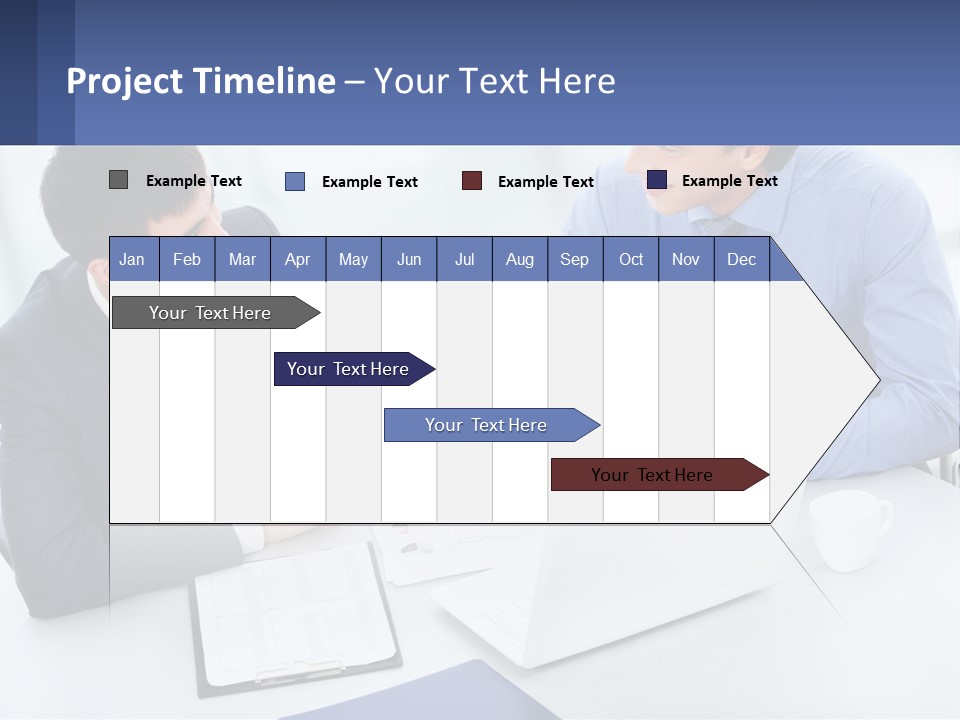 Two Men Sitting At A Table In Front Of A Laptop PowerPoint Template