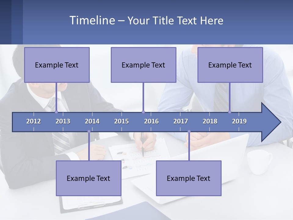Two Men Sitting At A Table In Front Of A Laptop PowerPoint Template