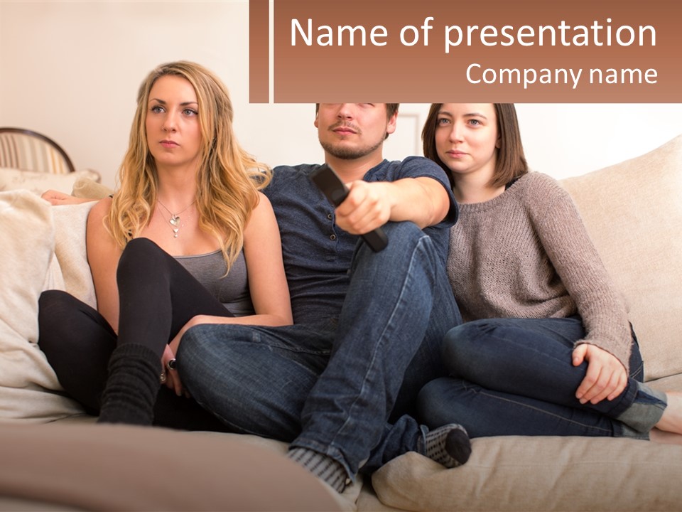 A Man And Woman Sitting On A Couch Pointing At Something PowerPoint Template