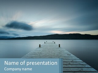 A Wooden Dock In The Middle Of A Body Of Water PowerPoint Template
