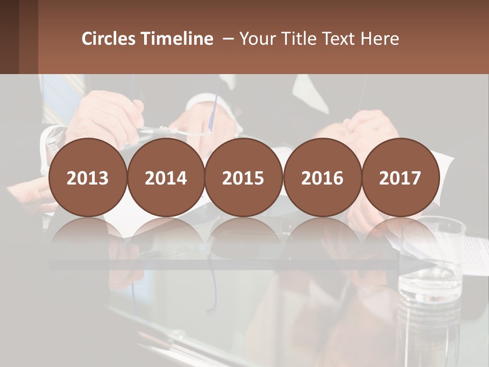 A Group Of Business People Sitting Around A Table PowerPoint Template