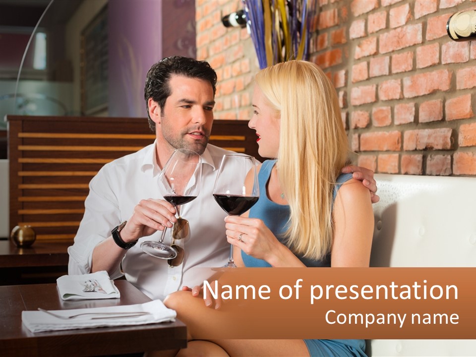 A Man And Woman Sitting At A Table Drinking Wine PowerPoint Template