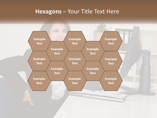 A Woman Sitting At A Desk In Front Of A Computer PowerPoint Template