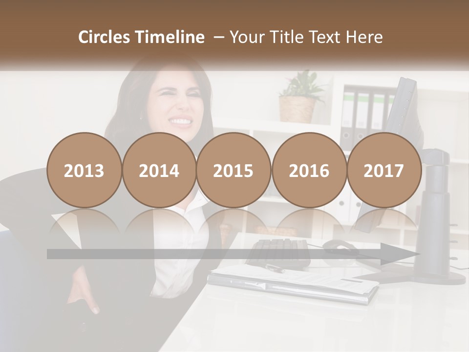 A Woman Sitting At A Desk In Front Of A Computer PowerPoint Template