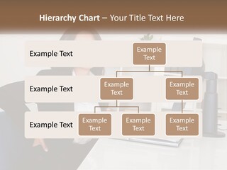 A Woman Sitting At A Desk In Front Of A Computer PowerPoint Template