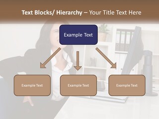 A Woman Sitting At A Desk In Front Of A Computer PowerPoint Template