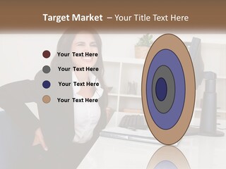 A Woman Sitting At A Desk In Front Of A Computer PowerPoint Template