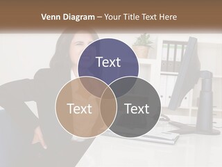 A Woman Sitting At A Desk In Front Of A Computer PowerPoint Template