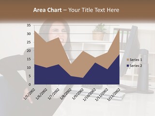 A Woman Sitting At A Desk In Front Of A Computer PowerPoint Template