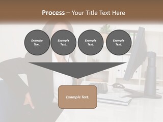 A Woman Sitting At A Desk In Front Of A Computer PowerPoint Template