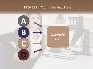 A Woman Sitting At A Desk In Front Of A Computer PowerPoint Template