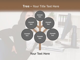 A Woman Sitting At A Desk In Front Of A Computer PowerPoint Template