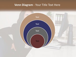 A Woman Sitting At A Desk In Front Of A Computer PowerPoint Template