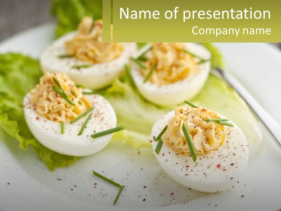 A White Plate Topped With Deviled Eggs Covered In Cheese PowerPoint Template