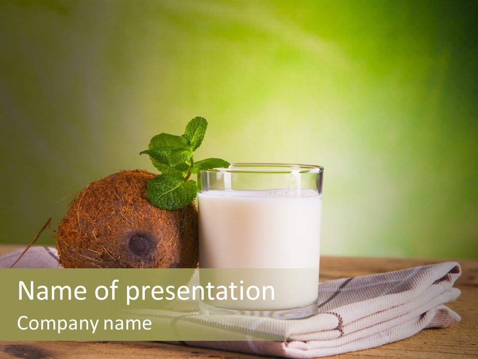 A Glass Of Milk Next To A Coconut On A Table PowerPoint Template