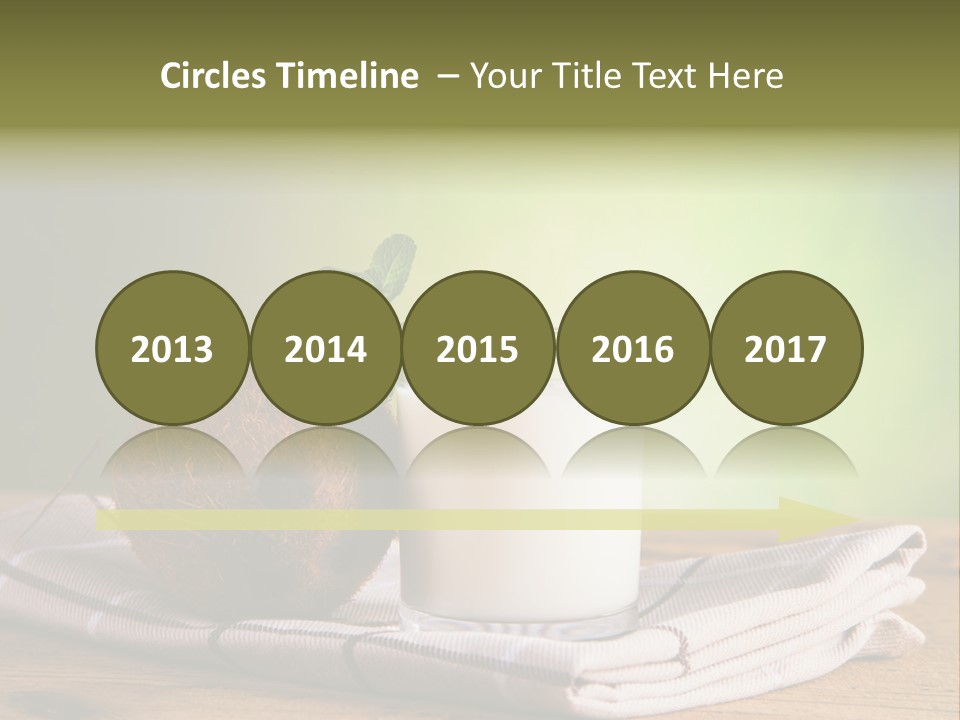 A Glass Of Milk Next To A Coconut On A Table PowerPoint Template