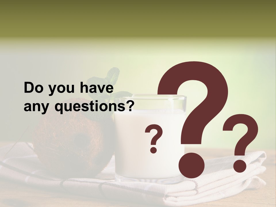 A Glass Of Milk Next To A Coconut On A Table PowerPoint Template