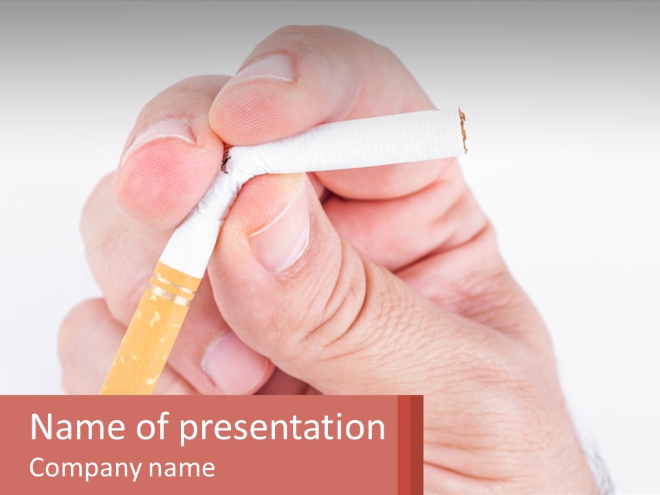 A Person Holding A Cigarette In Their Hand PowerPoint Template