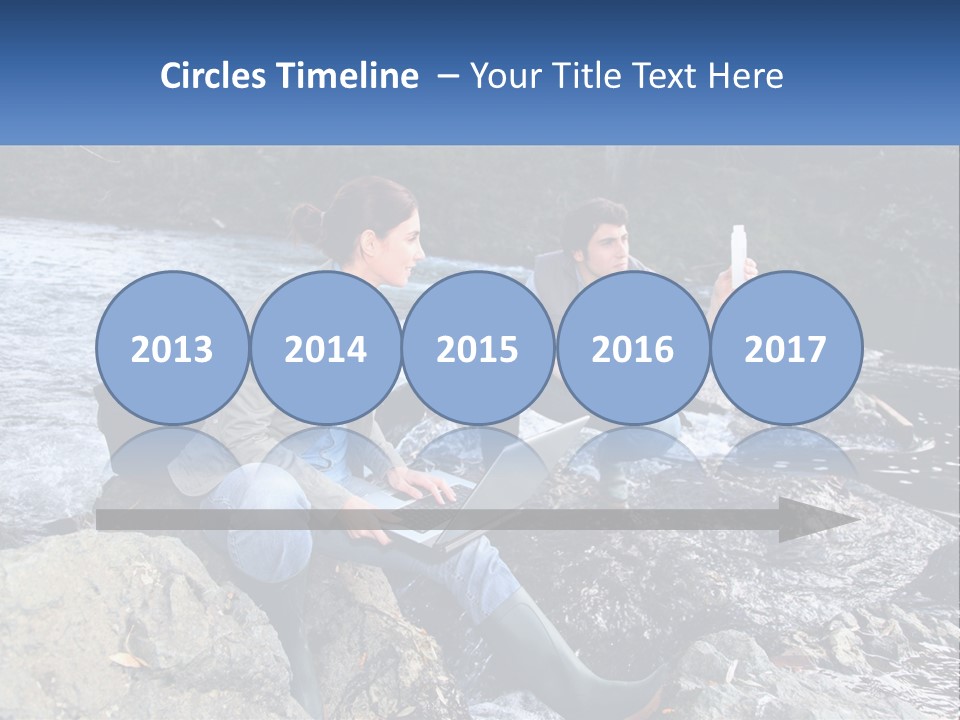 A Man And A Woman Sitting On Rocks With A Laptop PowerPoint Template