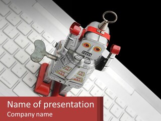 A Robot Keychain Sitting On Top Of A Keyboard PowerPoint Template