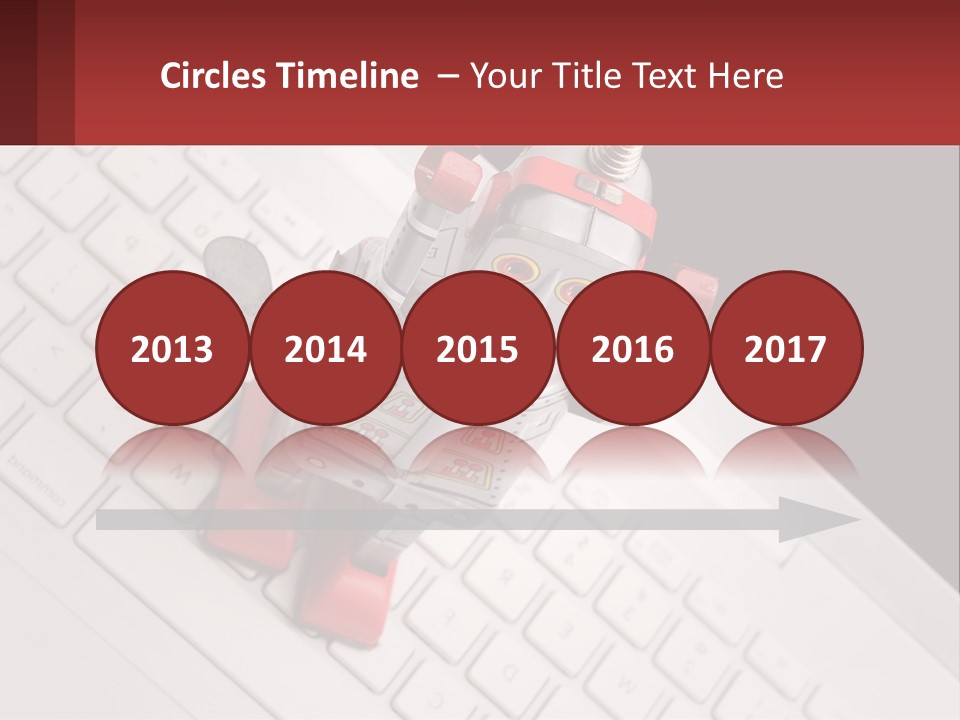 A Robot Keychain Sitting On Top Of A Keyboard PowerPoint Template