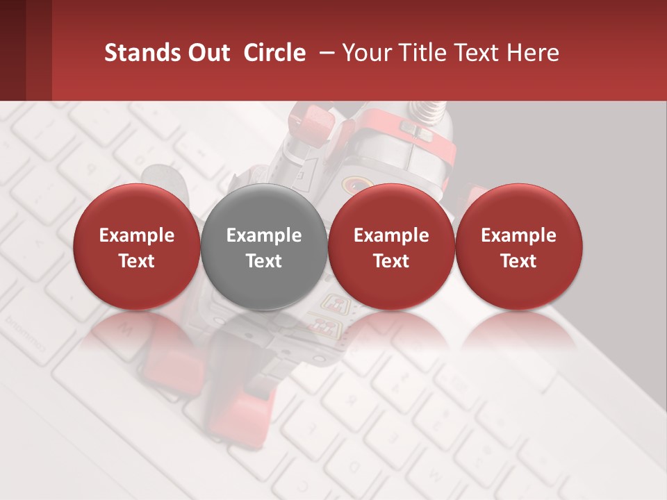 A Robot Keychain Sitting On Top Of A Keyboard PowerPoint Template