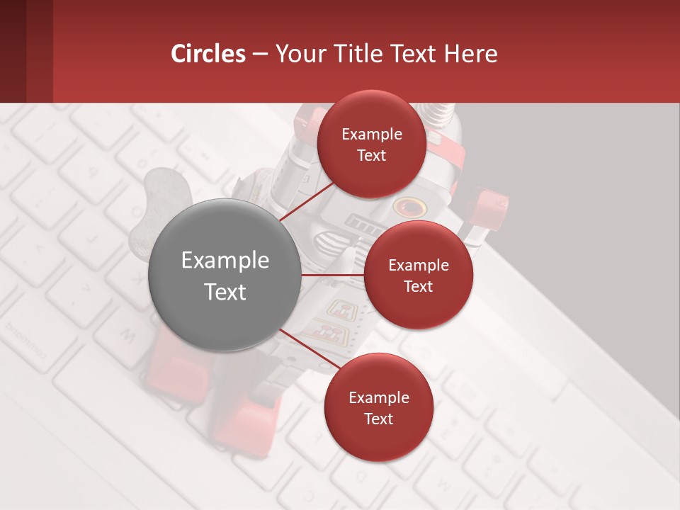 A Robot Keychain Sitting On Top Of A Keyboard PowerPoint Template