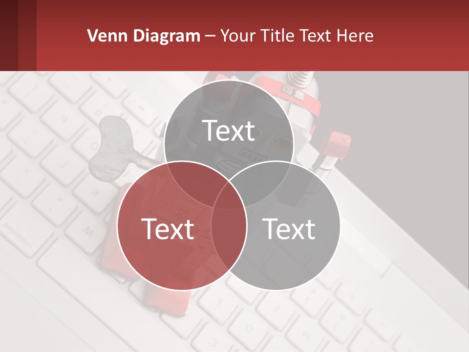 A Robot Keychain Sitting On Top Of A Keyboard PowerPoint Template