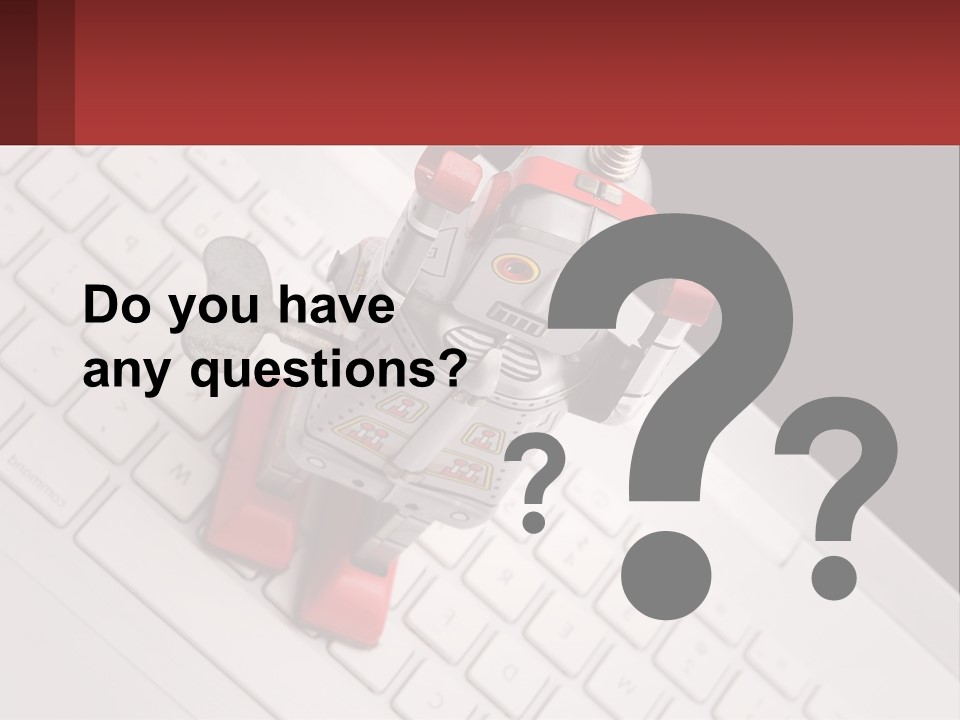 A Robot Keychain Sitting On Top Of A Keyboard PowerPoint Template