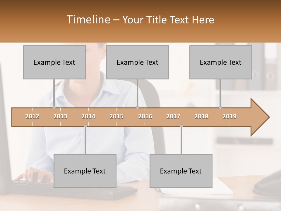 A Woman Sitting At A Desk In Front Of A Computer PowerPoint Template