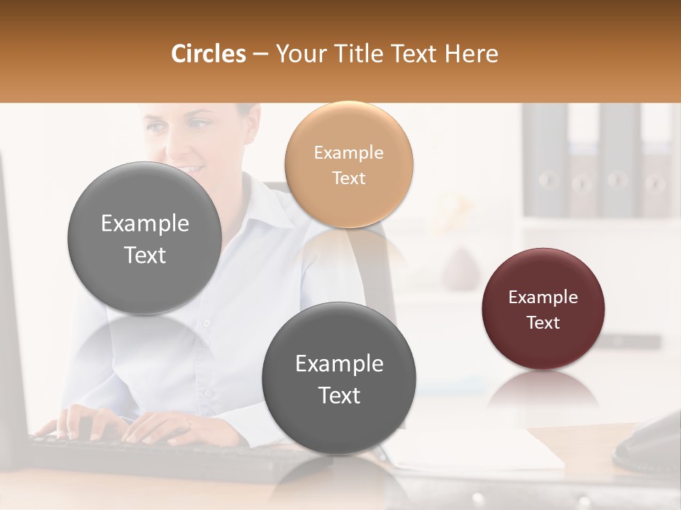 A Woman Sitting At A Desk In Front Of A Computer PowerPoint Template