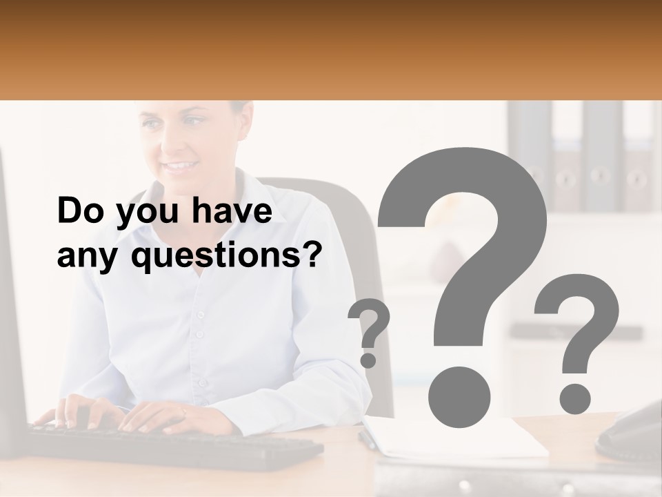 A Woman Sitting At A Desk In Front Of A Computer PowerPoint Template