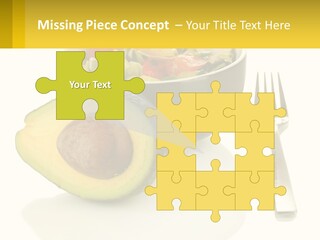 A Bowl Of Salad With An Avocado Next To A Fork PowerPoint Template