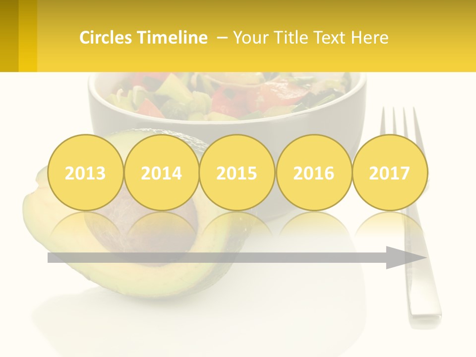 A Bowl Of Salad With An Avocado Next To A Fork PowerPoint Template