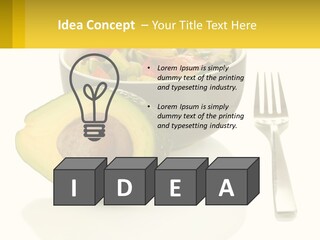 A Bowl Of Salad With An Avocado Next To A Fork PowerPoint Template