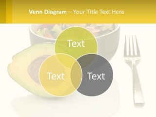 A Bowl Of Salad With An Avocado Next To A Fork PowerPoint Template