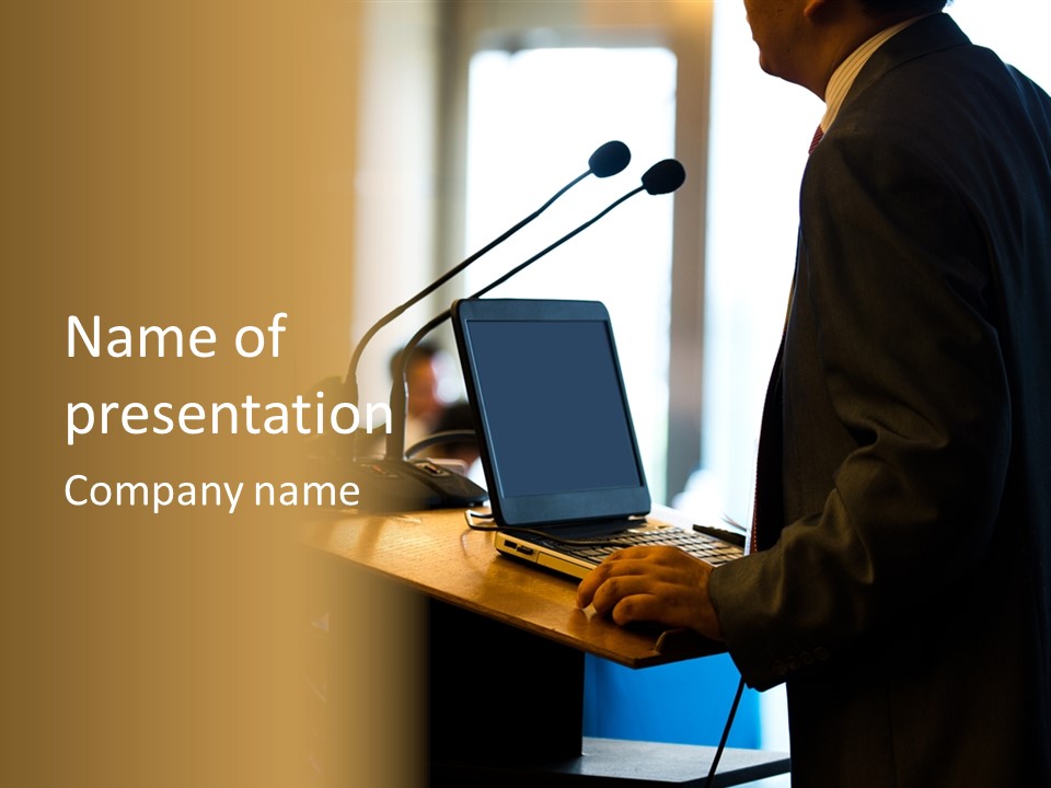A Man Standing At A Podium With A Laptop In Front Of Him PowerPoint Template