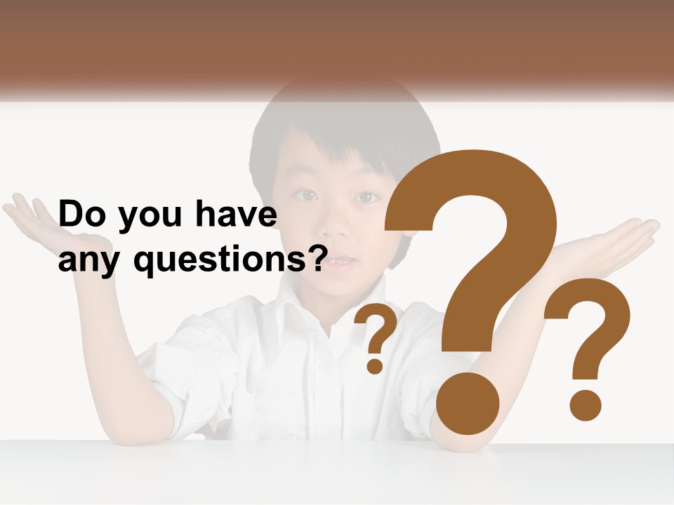 A Young Boy Sitting At A Table With His Hands Out PowerPoint Template