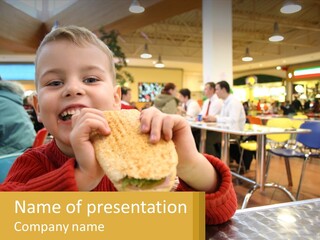A Young Boy Eating A Sandwich In A Restaurant PowerPoint Template
